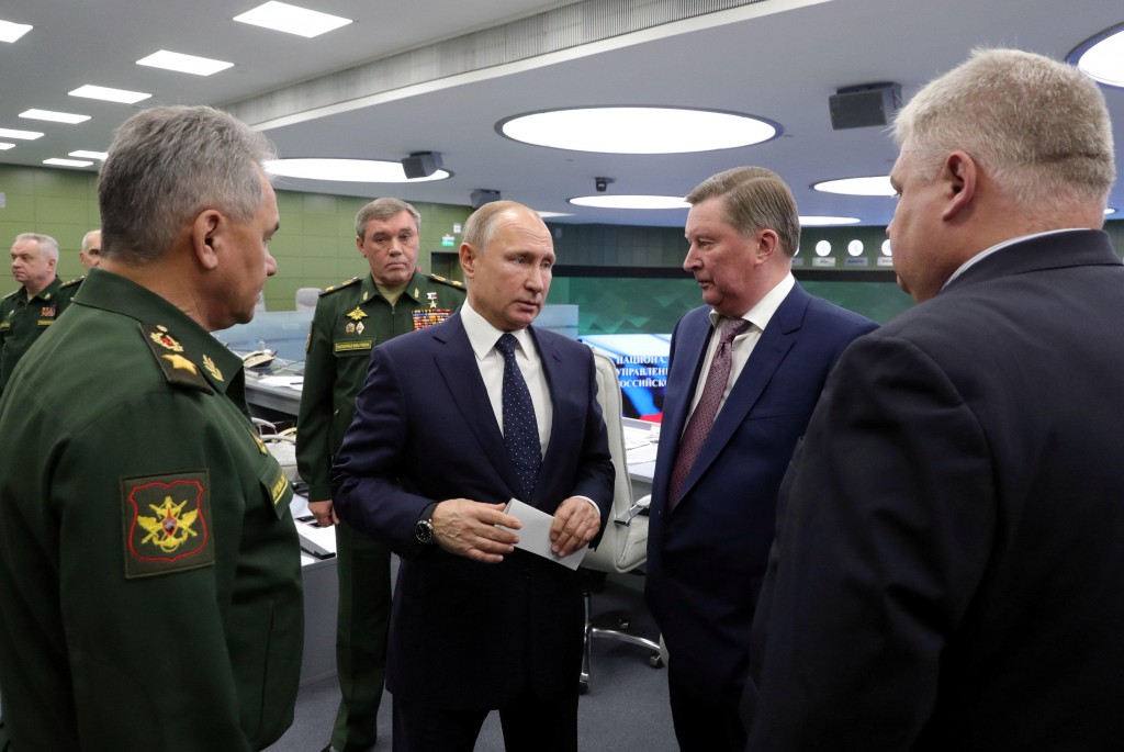 Russia's President Vladimir Putin (C) speaks with Special Presidential Representative for Environmental Protection