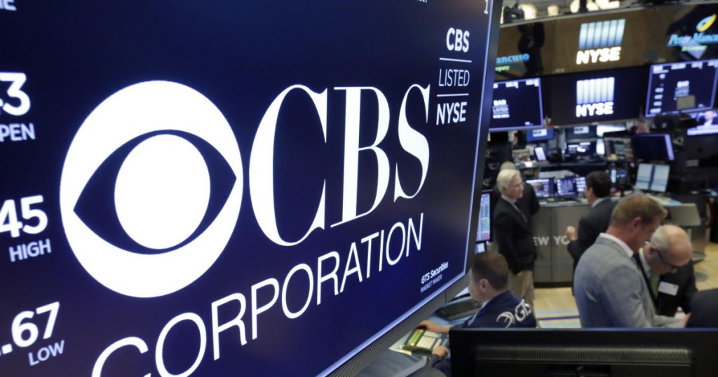 The logo for CBS Corporation is displayed above a trading post on the floor of the New York Stock Exchange