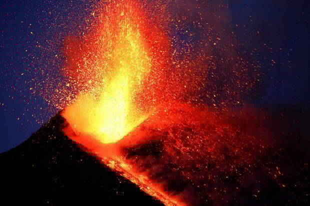 FILE PHOTO: Italy's Mount Etna, Europe's tallest and most active volcano, spews lava as it erupts on the southern island of Sicily 