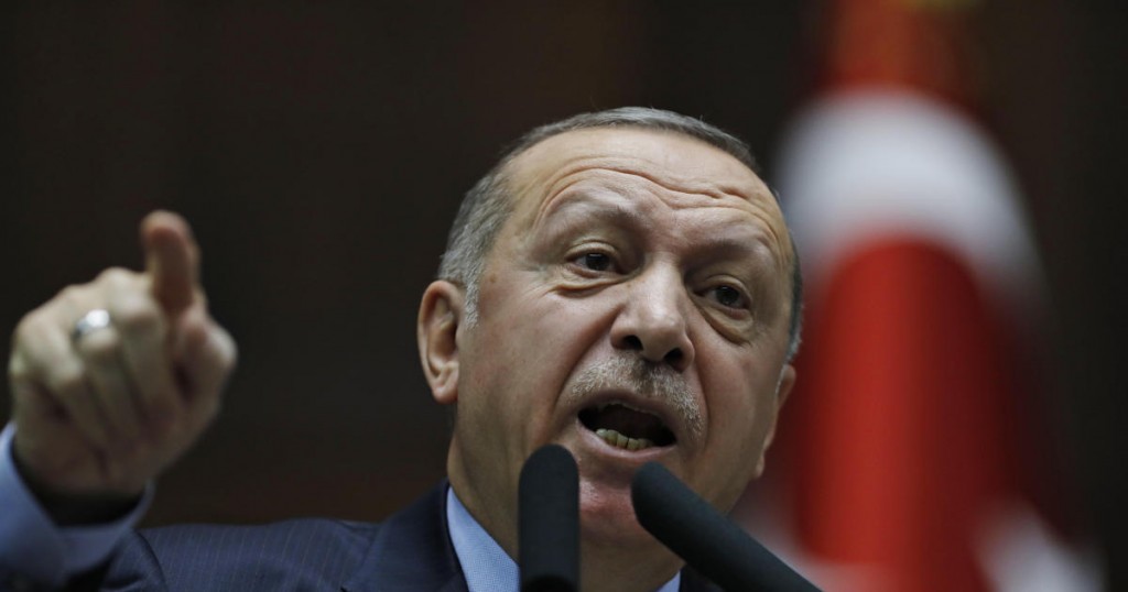 Turkey's President Recep Tayyip Erdogan gestures as he delivers a speech to MPs of his ruling Justice and Development Party (AKP) at the parliament in Ankara