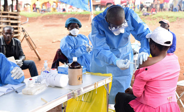 FILE PHOTO: A Congolese health worker administers Ebola vaccine to a woman who had contact with an Ebola sufferer in the village of Mangina in North Kivu province of the Democratic Republic of Congo