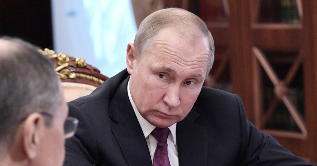 Russian President Vladimir Putin looks on during a meeting with Defence Minister Sergei Shoigu and Foreign Minister Sergei Lavrov at the Kremlin in Moscow