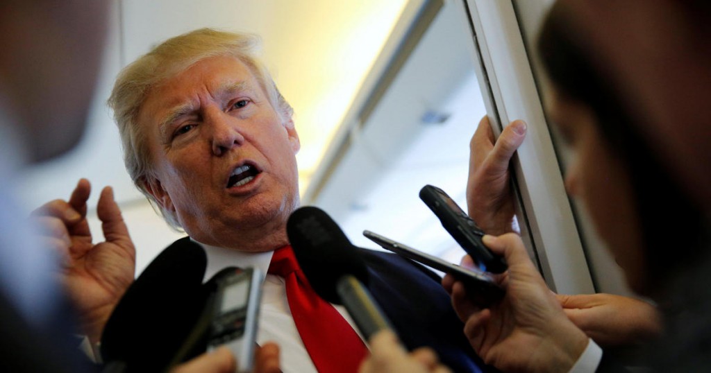 U.S. President Donald Trump takes questions from reporters en route to Hanoi