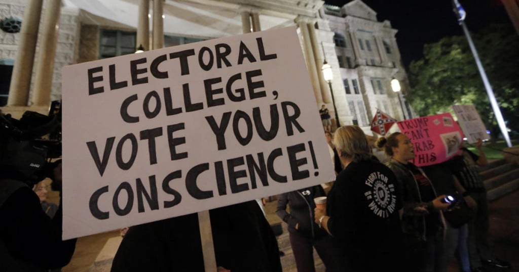 A small group protest outside the courthouse in opposition of President-elect Donald Trump
