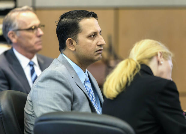 Nouman Raja sits between defense attorney Scott Richardson