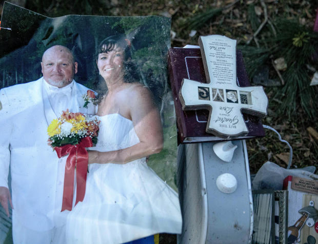A wedding photo of Carol Dean and David Wayne Dean sits in a pile of personal items Carol Dean recovered while sifting through the debris after a tornado destroyed their home a day earlier killing her husband in Beauregard