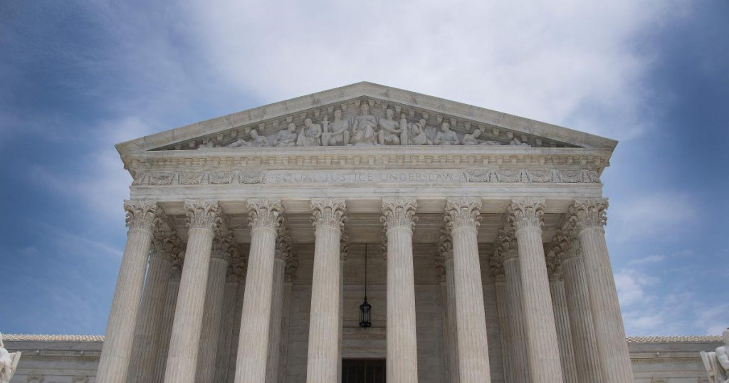 A police officer stands guard on the steps of the US Supreme Court in Washington