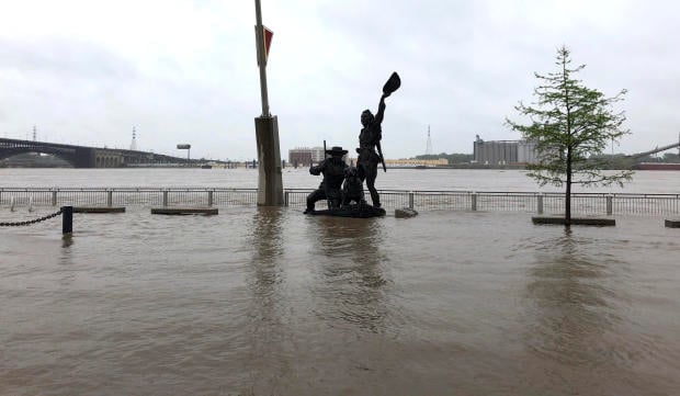 A statue of explorers Lewis and Clark is surrounded by floodwater along the St. Louis riverfront