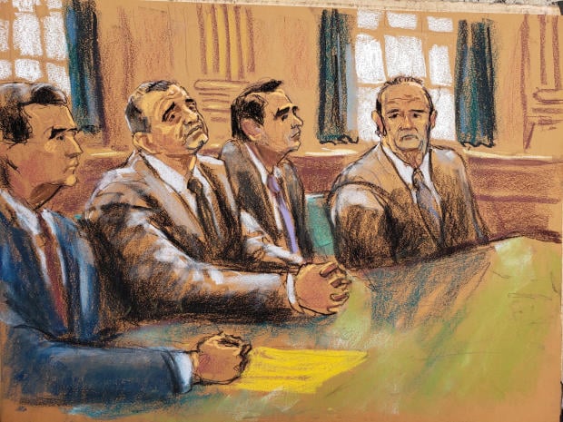 Ukrainian-American businessman Lev Parnas and Russian-born businessman Igor Fruman sit with their lawyers Edward MacMahon and Todd Blanche during their arraignment at the United States Courthouse in the Manhattan borough of New York City