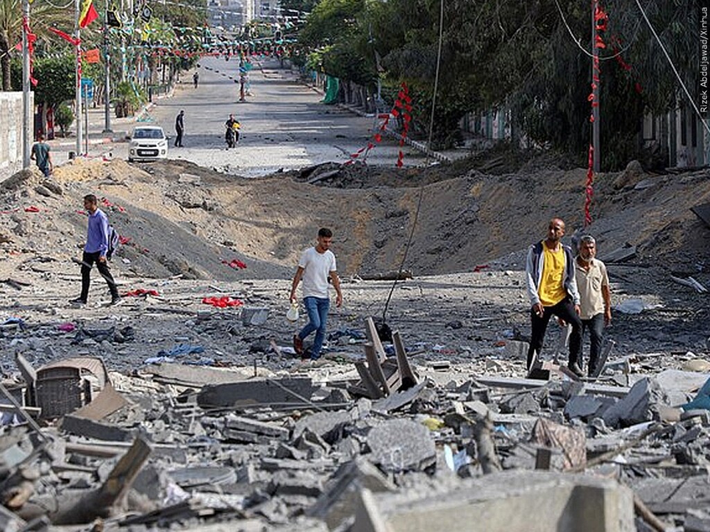 Citizens in Gaza traveling through destruction and debris
