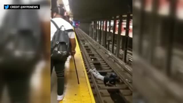 Ny:officer Rescues Man From Subway Tracks