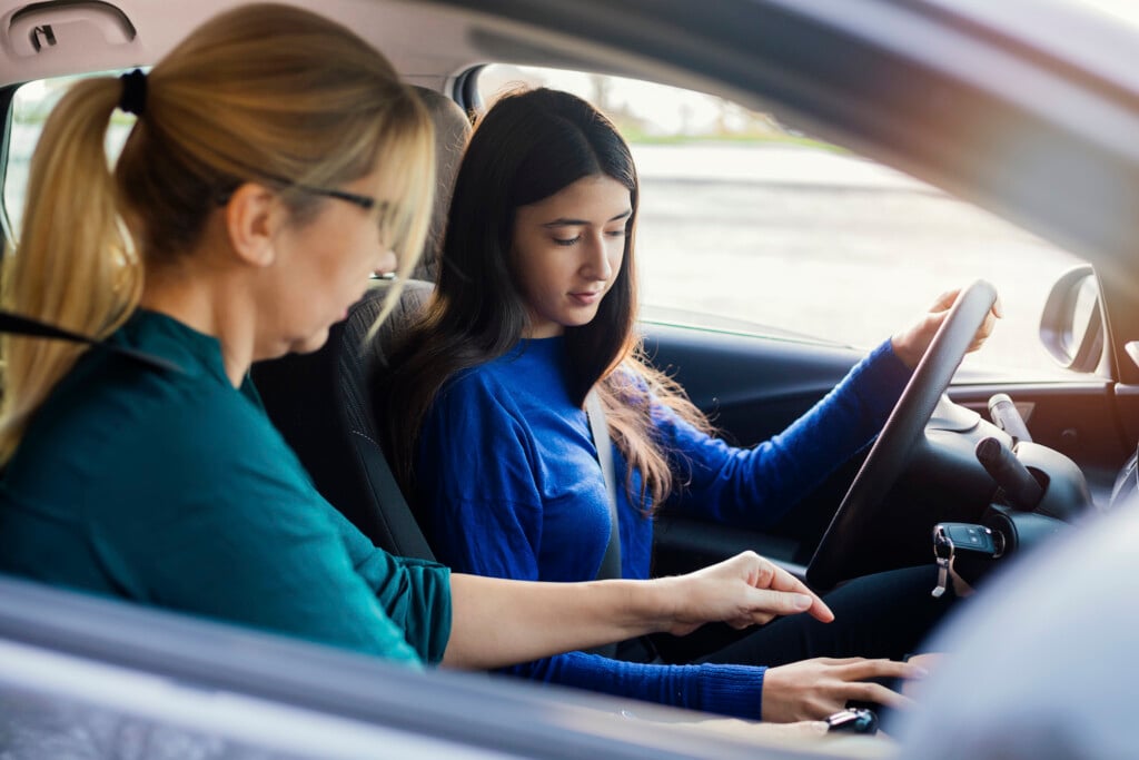 Teenager Having Driving Lesson With Female Instructor