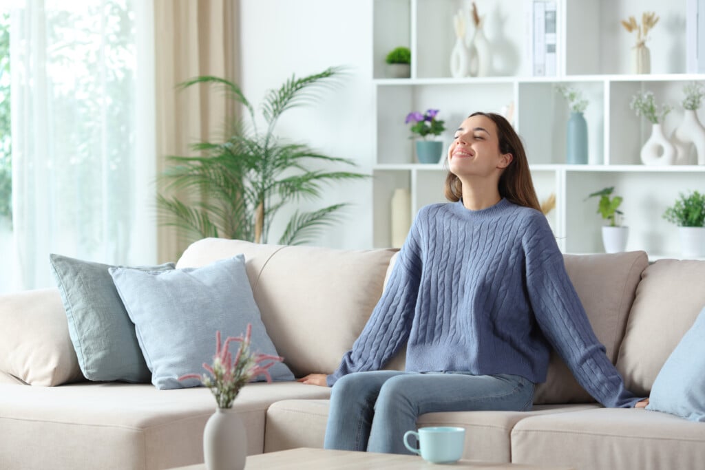 Happy Woman In Blue Breathing Fresh Air At Home