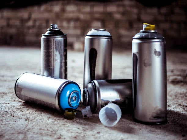 Used Graffiti Spray Paint Cans On The Ground
