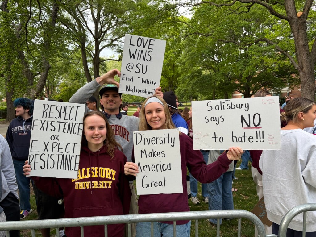 SU students hold signs saying "respect existence or expect resistence," "love wins @ SU, end 'white nationalism,'" "diversity makes American great," and "Salisbury says no to hate."