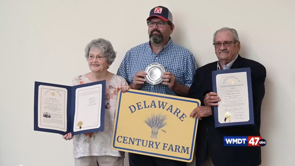 The Wright Family holds the sign reading "Delaware Century Farm," along with an engraved plate and legislative tributes.