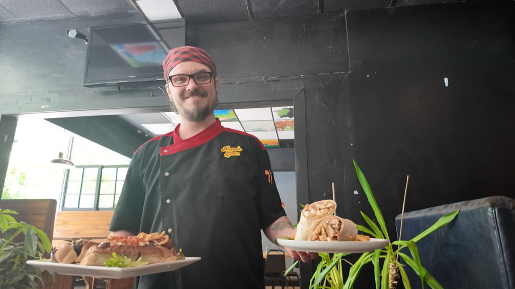Chef Daniel Burke poses with his one specials dish in each hand for May the Fourth.