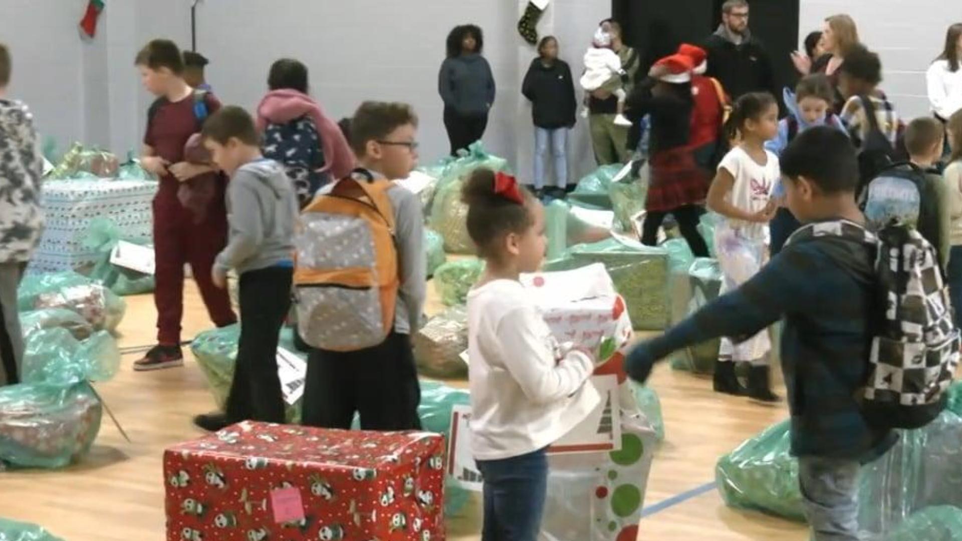 Boys and Girls Club children open gifts from members of the community