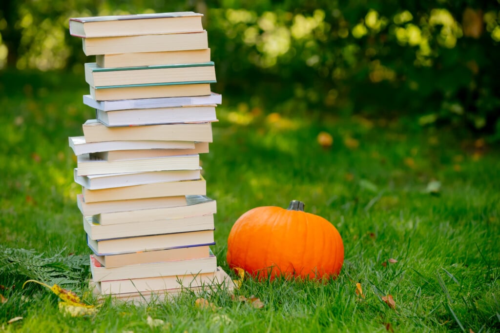 Pumpkin And Books Are On A Green Grass In A Garden