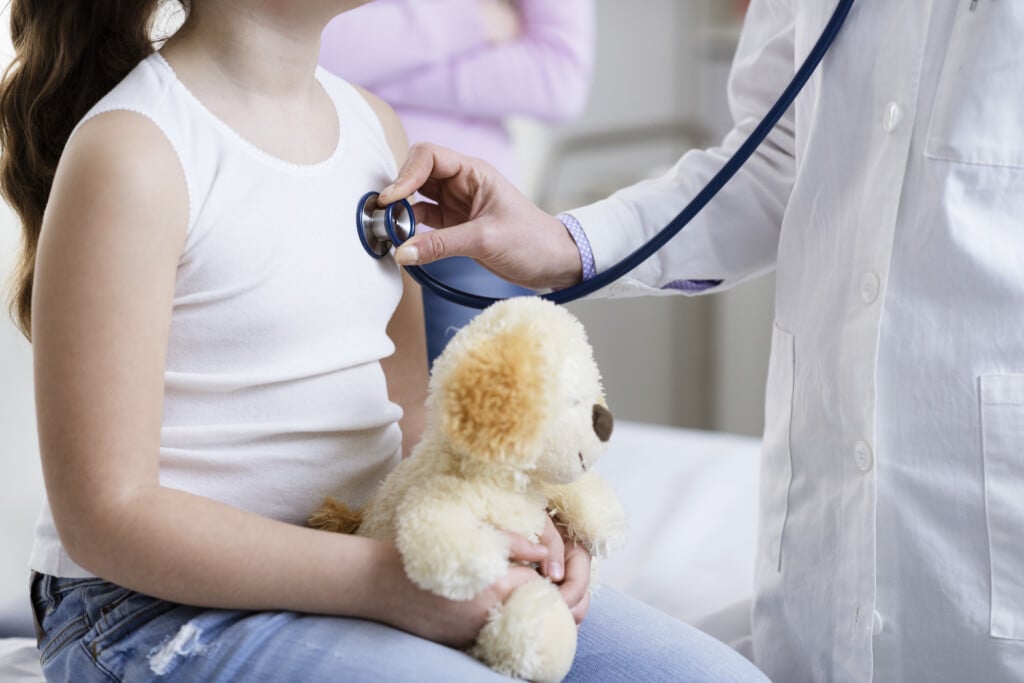 Doctor Checking A Girl's Heartbeat With A Stethoscope