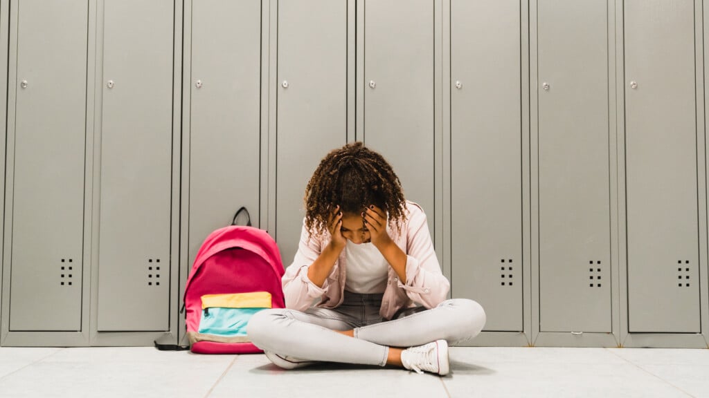 Troubles At School. Lonely Sad African American Schoolgirl Crying At School Hall