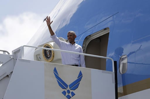 President Barack Obama waves as he boards Air Force One at Joint Base Pearl Harbor-Hickam