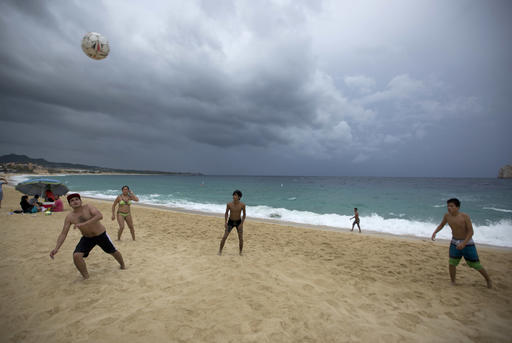 People play on El Medano Beach before the arrival of Hurricane Newton in Cabo San Lucas