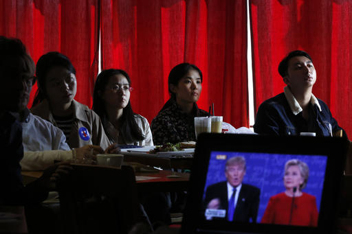 Chinese students watch live broadcasting of the U.S. presidential debate between Democratic presidential nominee Hillary Clinton and Republican presidential nominee Donald Trump