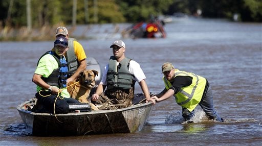 South Edgecombe Fire and Rescue workers rescue several dogs that were trapped in homes flooded by rising water from Town Creek in Pinetops