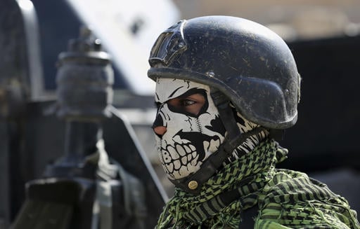 A member of Iraq's elite counterterrorism forces stands guard in the town of Bartella