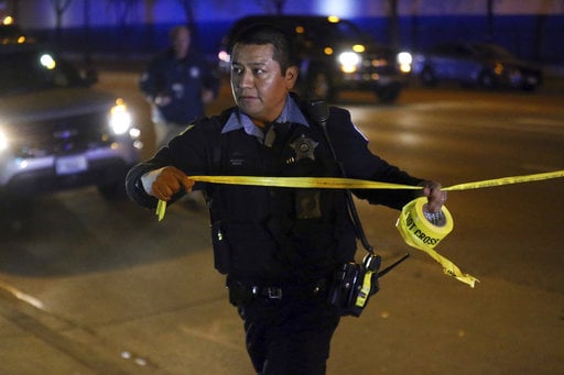 Chicago police investigate the scene where two police officers were shot on South Ashland Avenue in Chicago on Tuesday