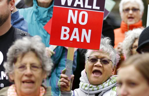 Protesters wave signs and chant during a demonstration against President Donald Trump's revised travel ban