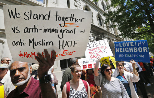 Protesters hold signs and march outside the US 4th Circuit Court of Appeals in Richmond