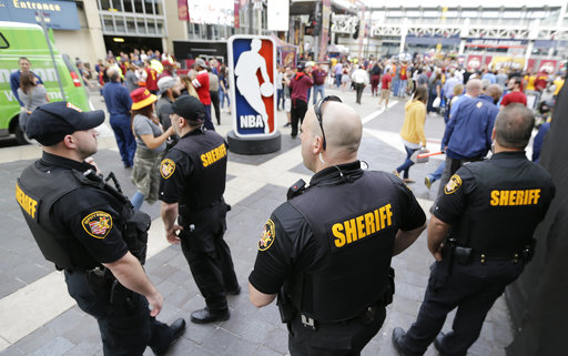 Sheriff's Deputies keep watch on fans as they enter Quicken Loans Arena for Game 4 of the NBA basketball Eastern Conference finals between the Boston Celtics and the Cleveland Cavaliers
