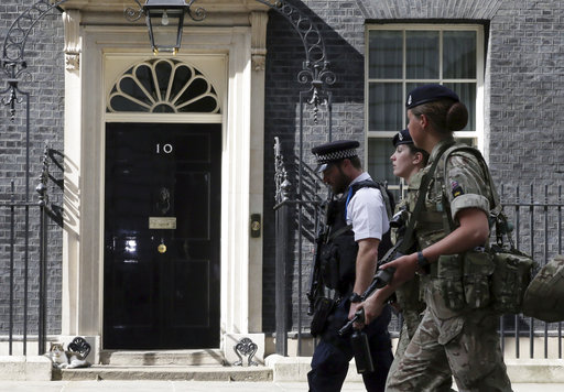 Members of the army join a police officer outside 10 Downing Street in London