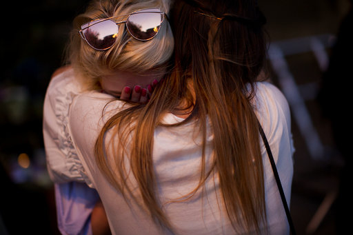 People cry after a vigil in Albert Square