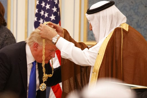Saudi King Salman presents President Donald Trump with The Collar of Abdulaziz Al Saud Medal at the Royal Court Palace