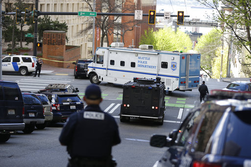 A Seattle Police vehicle turns near the scene of a shooting involving several police officers in downtown Seattle