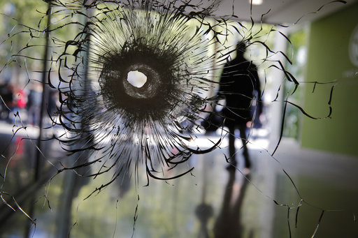 A bullet hole is pictured on a shopwindow of the Champs Elysees boulevard in Paris