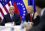 Florida Gov. Rick Scott listens at right as Vice President Mike Pence speaks during a meeting with members of the Venezuelan exile community