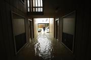 Steven Hathaway searches for people to help in an apartment complex as floodwaters from Tropical Storm Harvey rise Tuesday