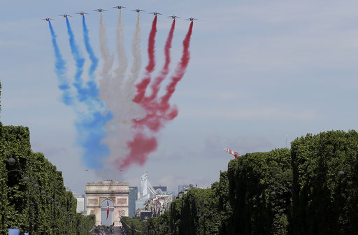 French Alphajets of the Patrouille de France fly over the Champs Elysees avenue
