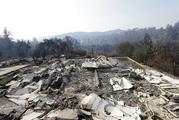 A swimming pool lies among the charred remains of a home destroyed by wildfires in Santa Rosa