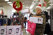 Joey Ellis adds to his armful of items while shopping for deals at a J.C. Penney store
