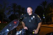Chula Vista police officer Fred Rowbotham stands next to his motorcycle Thursday