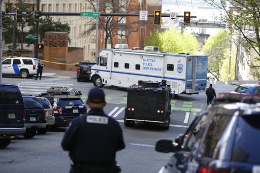 A Seattle Police vehicle turns near the scene of a shooting involving several police officers in downtown Seattle