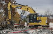 Work crews remove debris a the site of a home destroyed by fires in the Coffey Park area of Santa Rosa