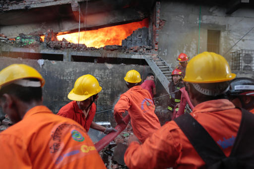 Firefighters work to put out the fire at a packaging factory in Tongi industy area outside Dhaka