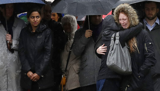 A girl cries prior to participating in a moment of silence to remember attack victims in the London Bridge area of London on Tuesday