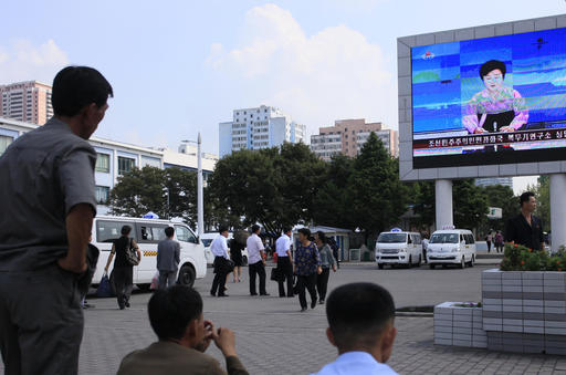 North Koreans watch a news report regarding a nuclear test on a large screen outside the Pyongyang Station in Pyongyang